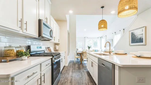 a kitchen with stainless steel appliances a stove sink and cabinets