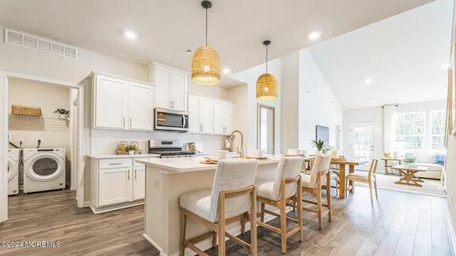 a view of a kitchen with furniture and wooden floor