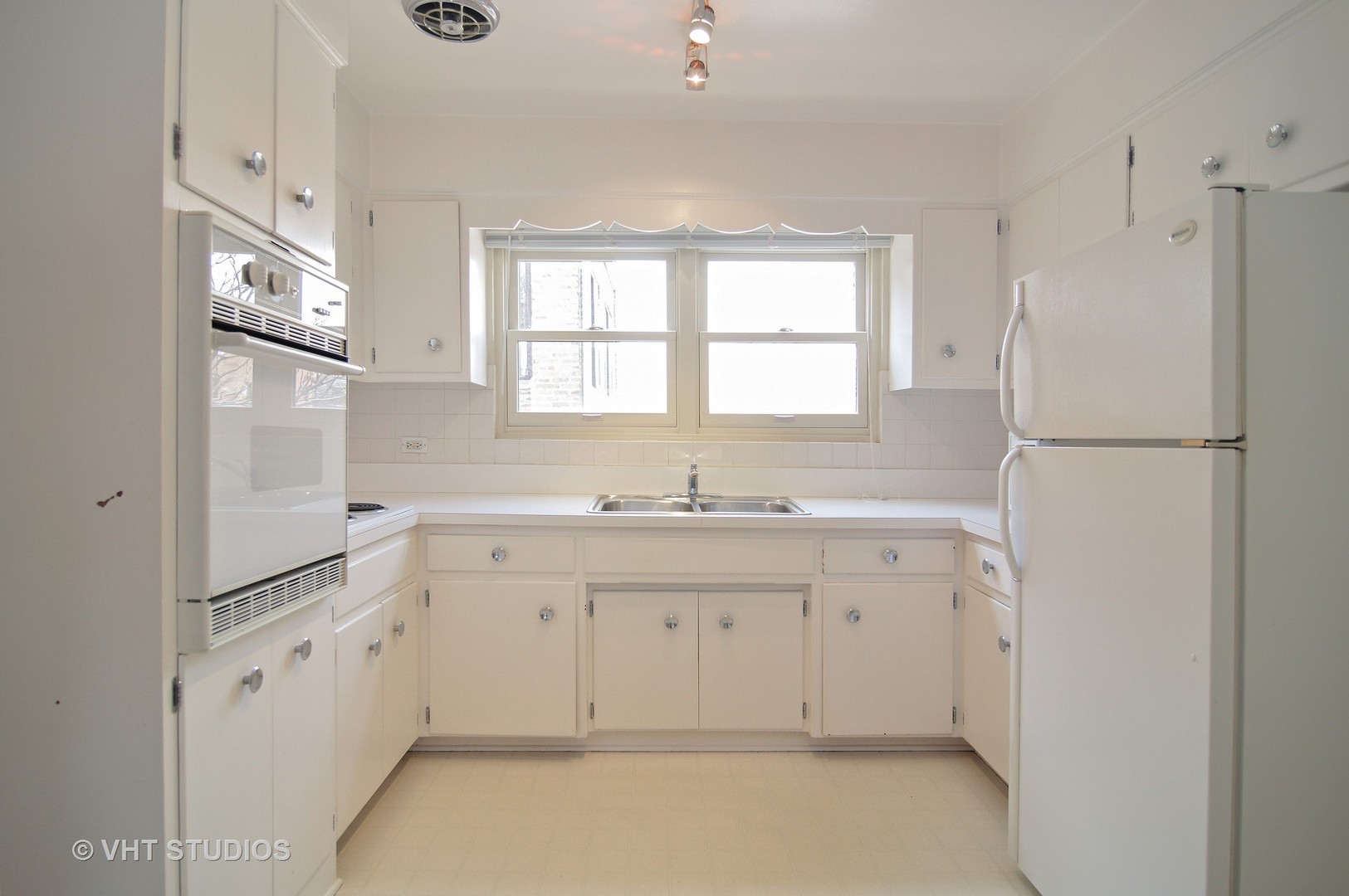 501 Sheridan Road, Unit 3C Evanston, IL 60202 - Photo 3 of 10 a kitchen with white cabinets and white appliances