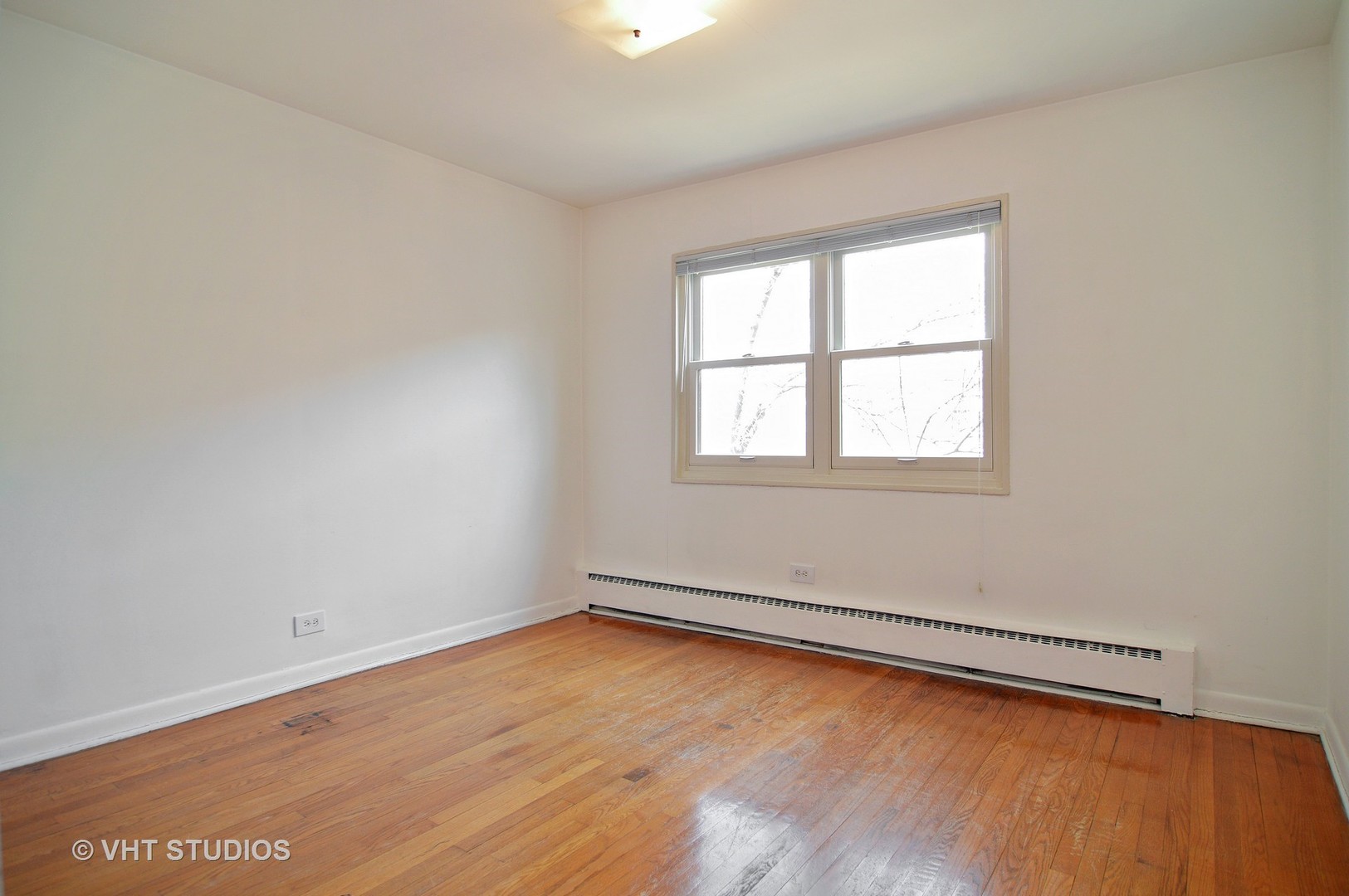 501 Sheridan Road, Unit 3C Evanston, IL 60202 - Photo 8 of 10 an empty room with wooden floor and windows