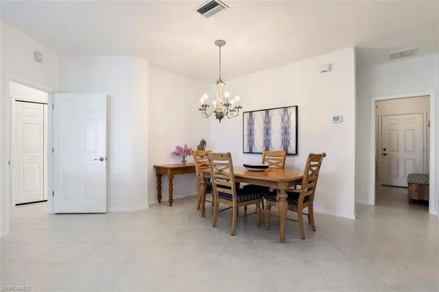 a view of a dining room with furniture and chandelier