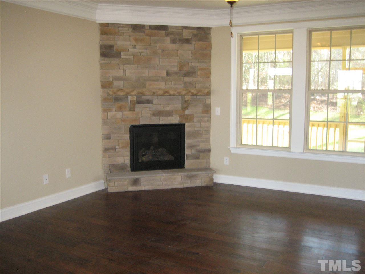 3618 Greenville Loop Road Wake Forest, NC 27587 - Photo 7 of 25 Family room Offers Corner Stone fireplace - 3-Piece Crown molding - Hardwoods - Lots of Natural Light