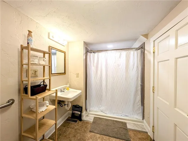 a spacious bedroom with a bed and a couch