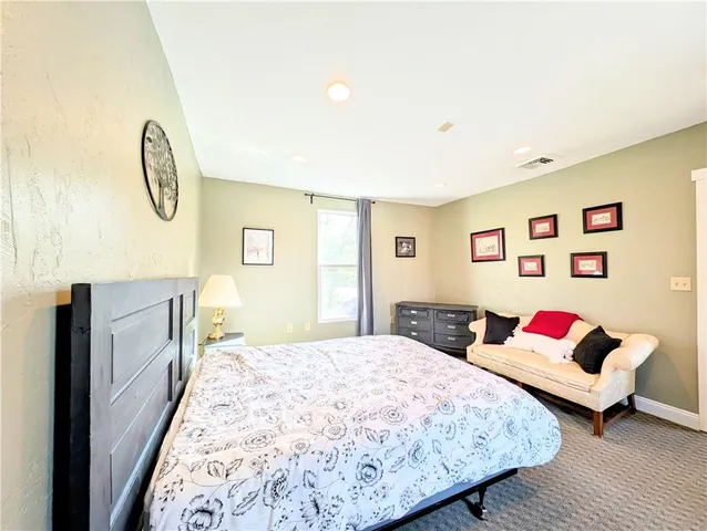 a bed room with a bed and a window