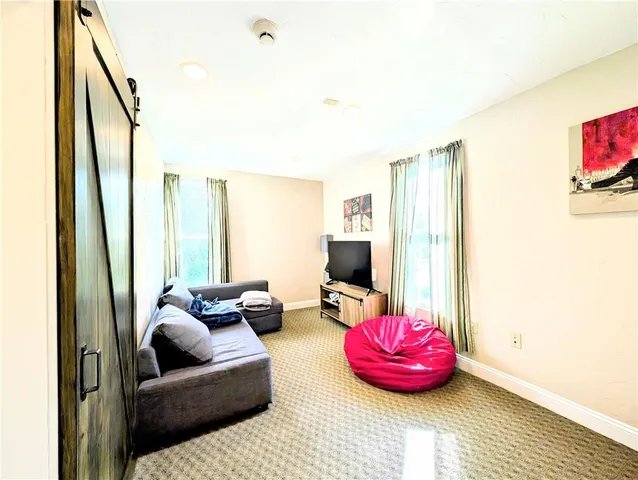 a bathroom with a toilet sink vanity and mirror