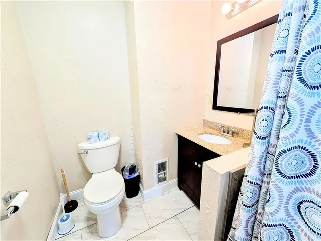 a view of a house with a yard and a tree