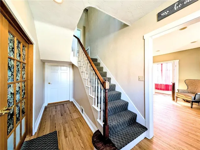 a view of entryway and hall with wooden floor