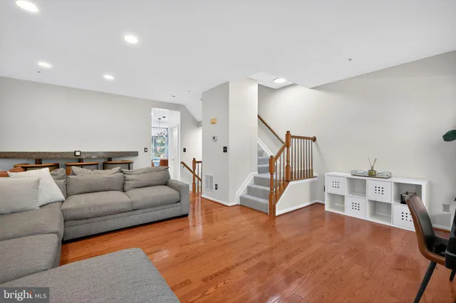a living room with furniture and wooden floor