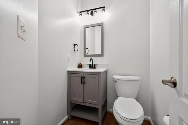 a white toilet sitting next to a bathroom sink