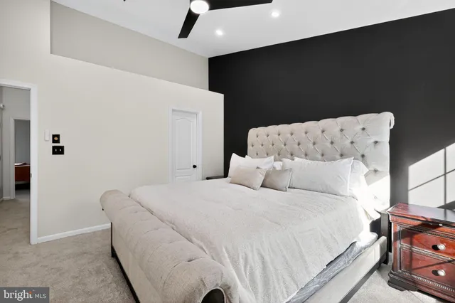 a large white bed in a small room