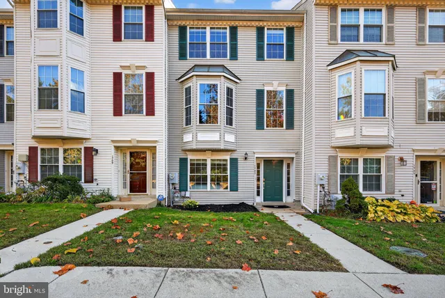 front view of a brick house with a yard