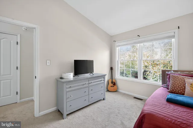 a bedroom with furniture and flat screen tv