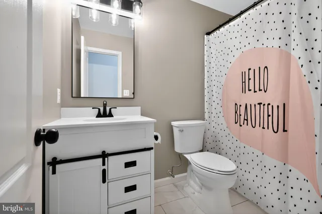 a bathroom with a sink toilet and mirror