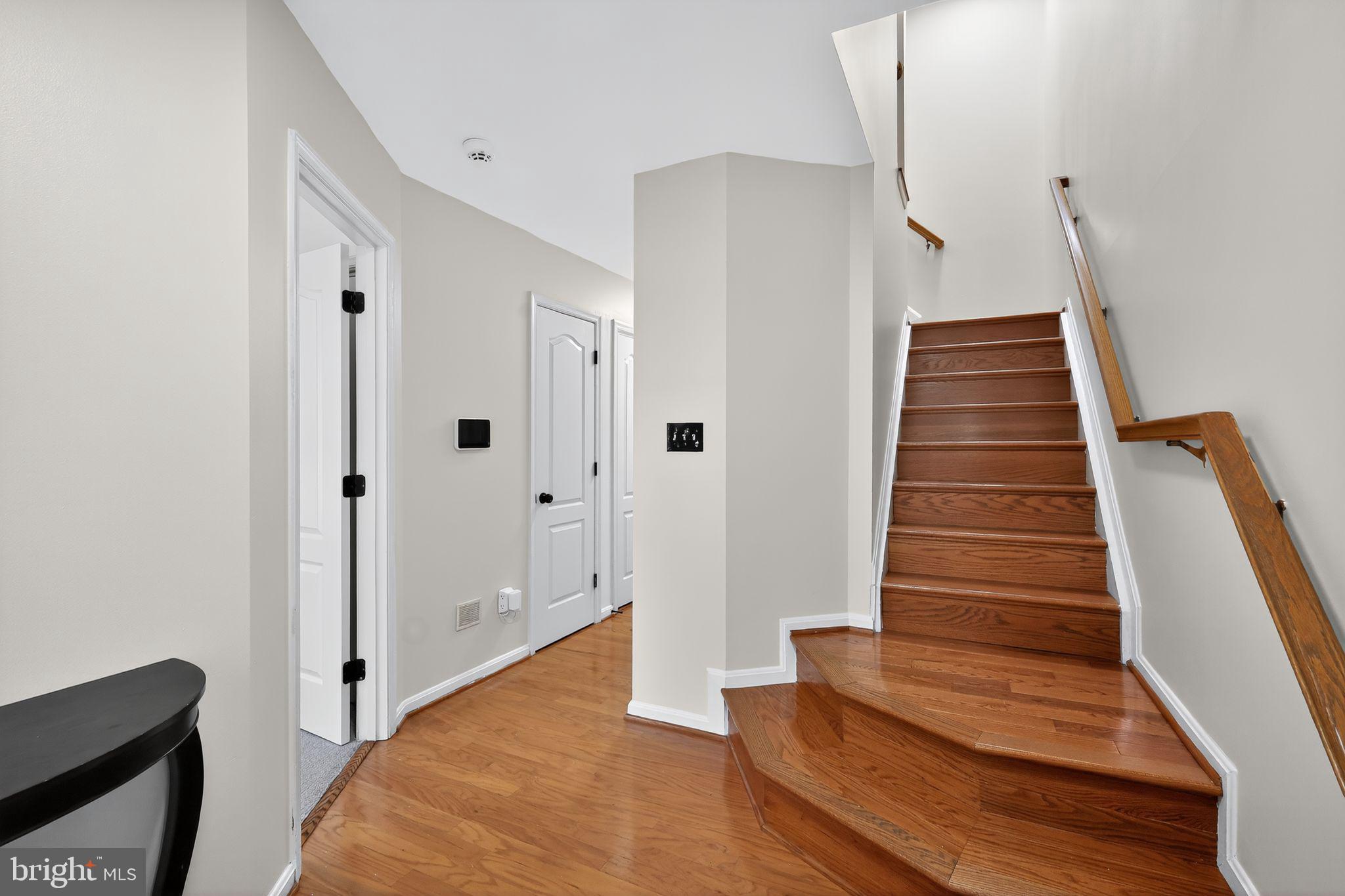 1707 Severn Tree Court Severn, MD 21144 - Photo 3 of 37 a view of a hallway with wooden floor and entryway