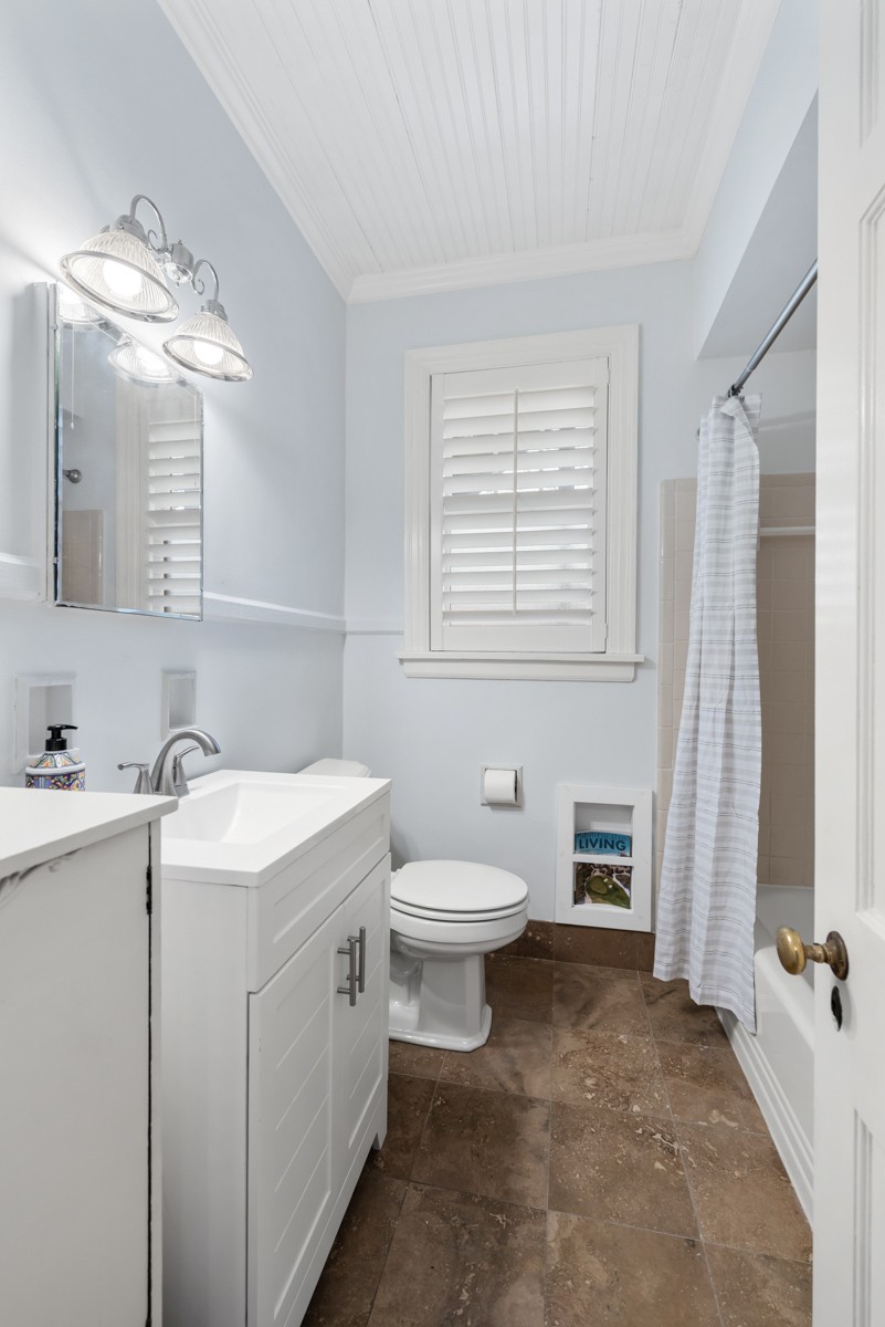 1002 Sutton Hill Road Nashville, TN 37204 - Photo 13 of 40 a bathroom with a toilet sink and mirror