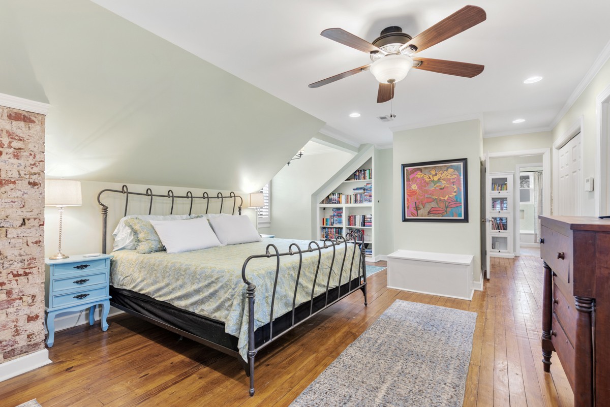 1002 Sutton Hill Road Nashville, TN 37204 - Photo 14 of 40 a bedroom with a bed and a chandelier