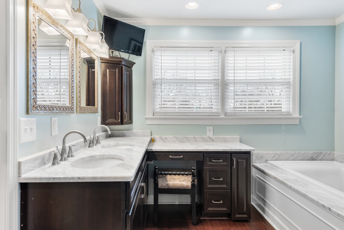 1002 Sutton Hill Road Nashville, TN 37204 - Photo 16 of 40 a bathroom with a granite countertop sink a bathtub and next to a window