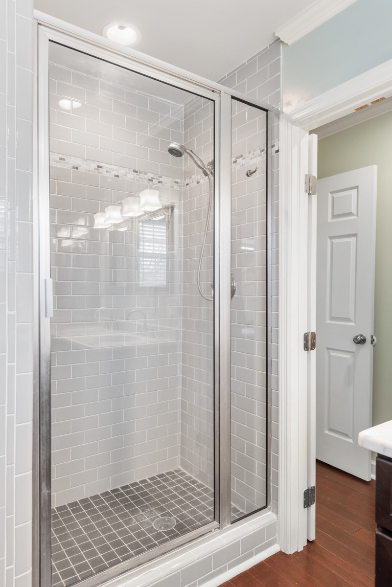 1002 Sutton Hill Road Nashville, TN 37204 - Photo 17 of 40 a bathroom with a glass shower door