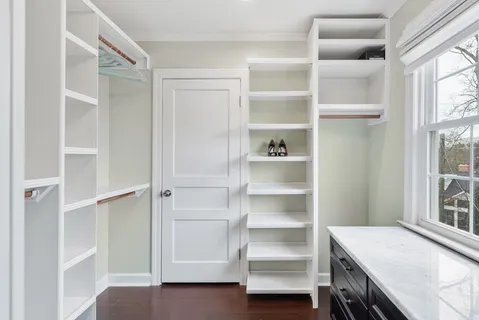 a view of walk in closet with empty racks