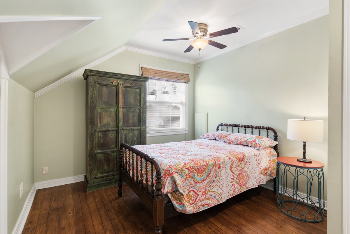 1002 Sutton Hill Road Nashville, TN 37204 - Photo 23 of 40 a bedroom with a bed and a chandelier