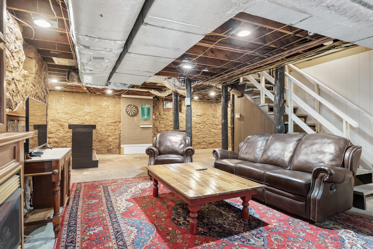 1002 Sutton Hill Road Nashville, TN 37204 - Photo 26 of 40 a living room with furniture and a chandelier