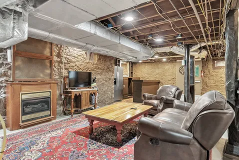 a living room with furniture a flat screen tv and a fireplace