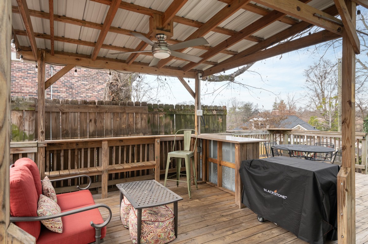 1002 Sutton Hill Road Nashville, TN 37204 - Photo 33 of 40 a balcony of a house with wooden floor outdoor seating and outdoor space