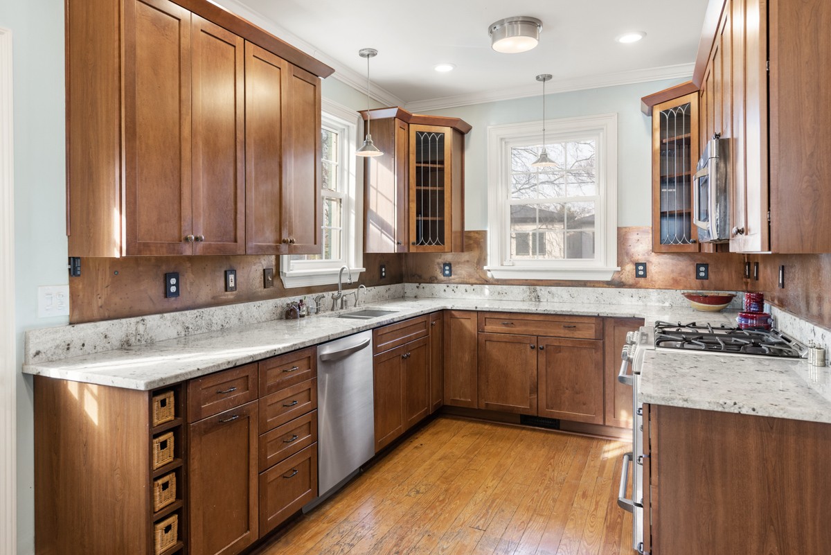 1002 Sutton Hill Road Nashville, TN 37204 - Photo 5 of 40 a kitchen with stainless steel appliances granite countertop wooden cabinets a sink and dishwasher with wooden floor