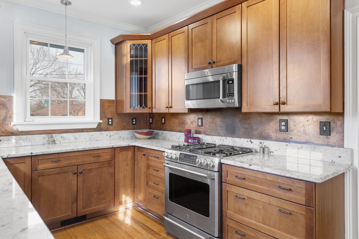 1002 Sutton Hill Road Nashville, TN 37204 - Photo 7 of 40 a kitchen with stainless steel appliances granite countertop a sink stove and microwave