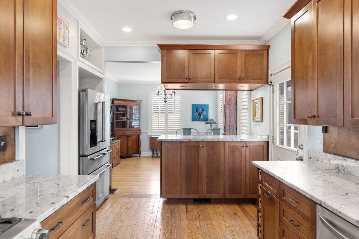 1002 Sutton Hill Road Nashville, TN 37204 - Photo 8 of 40 a kitchen with stainless steel appliances granite countertop a sink a stove and a refrigerator