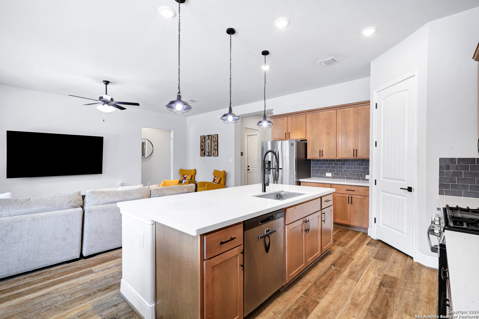 110 Giverny Boerne, TX 78006 - Photo 11 of 31 a kitchen with a sink a counter top space stainless steel appliances and a chandelier
