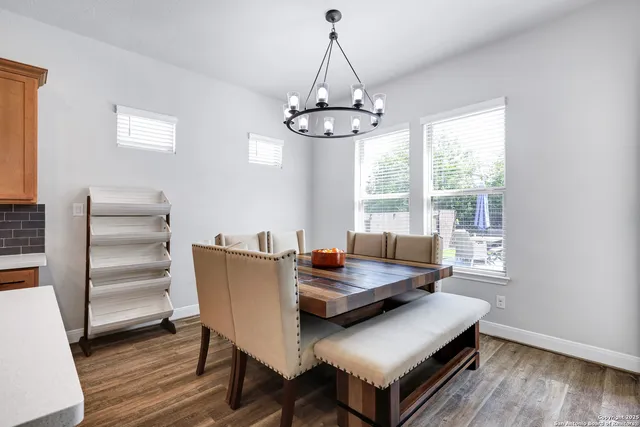 a living room with furniture a window and wooden floor