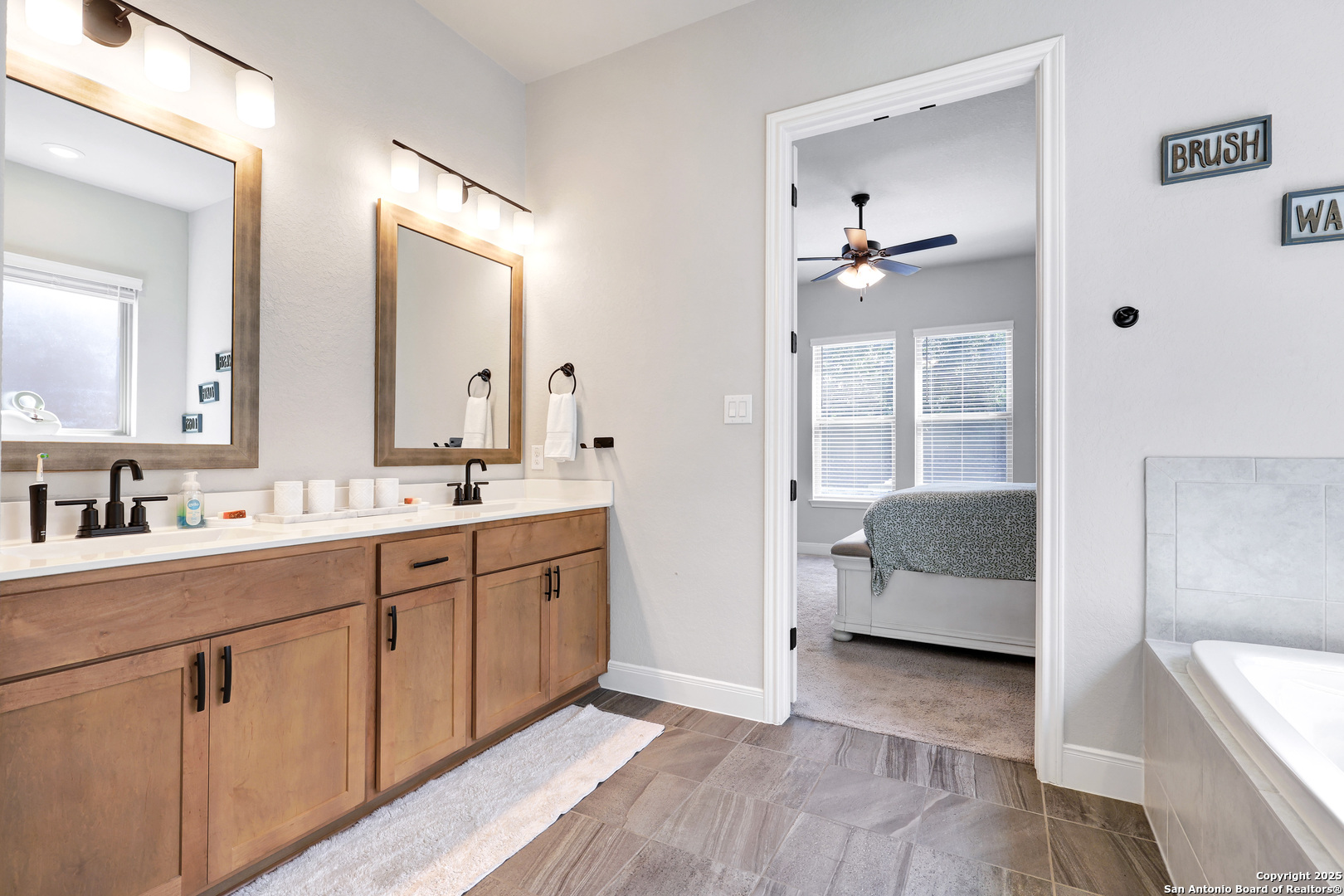 110 Giverny Boerne, TX 78006 - Photo 17 of 31 a en suite bathroom with double vanity a sink and a mirror