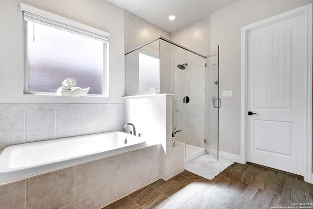 a spacious bathroom with a tub and a shower