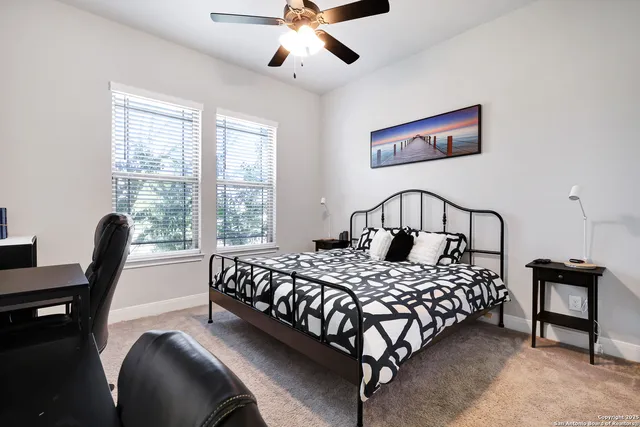 a bedroom with a bed chairs and a window