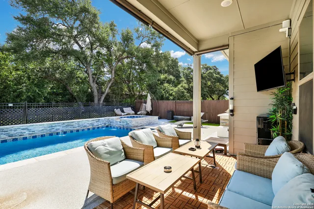 a view of a patio with couches table and chairs with potted plants