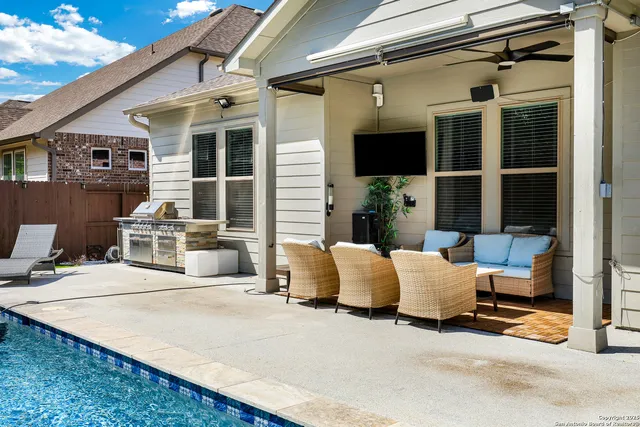 a building outdoor space with patio furniture and potted plants