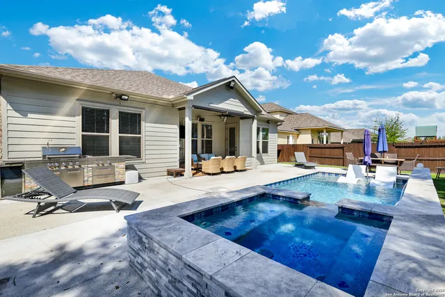a view of a house with swimming pool and sitting area