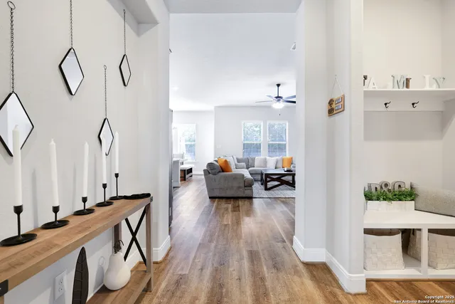 a living room with furniture and a wooden floor