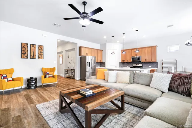 a living room with furniture and kitchen view