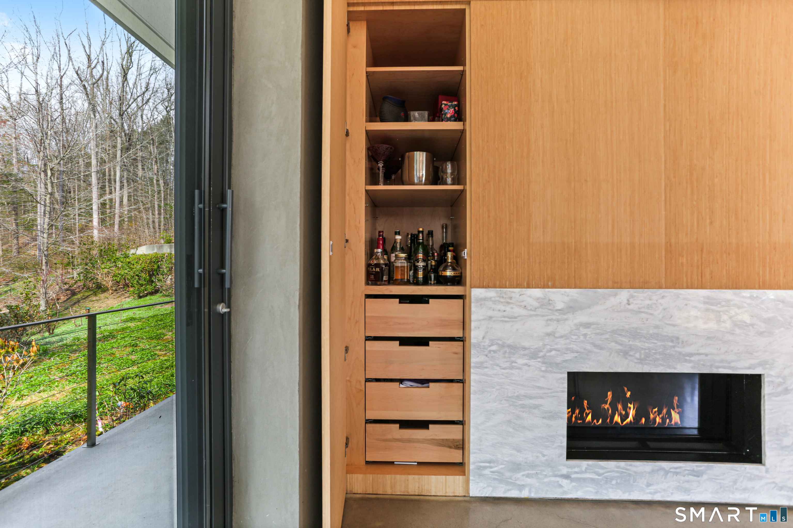 52 Valley Forge Road Weston, CT 06883 - Photo 15 of 38 a room with a fireplace and a floor to ceiling window