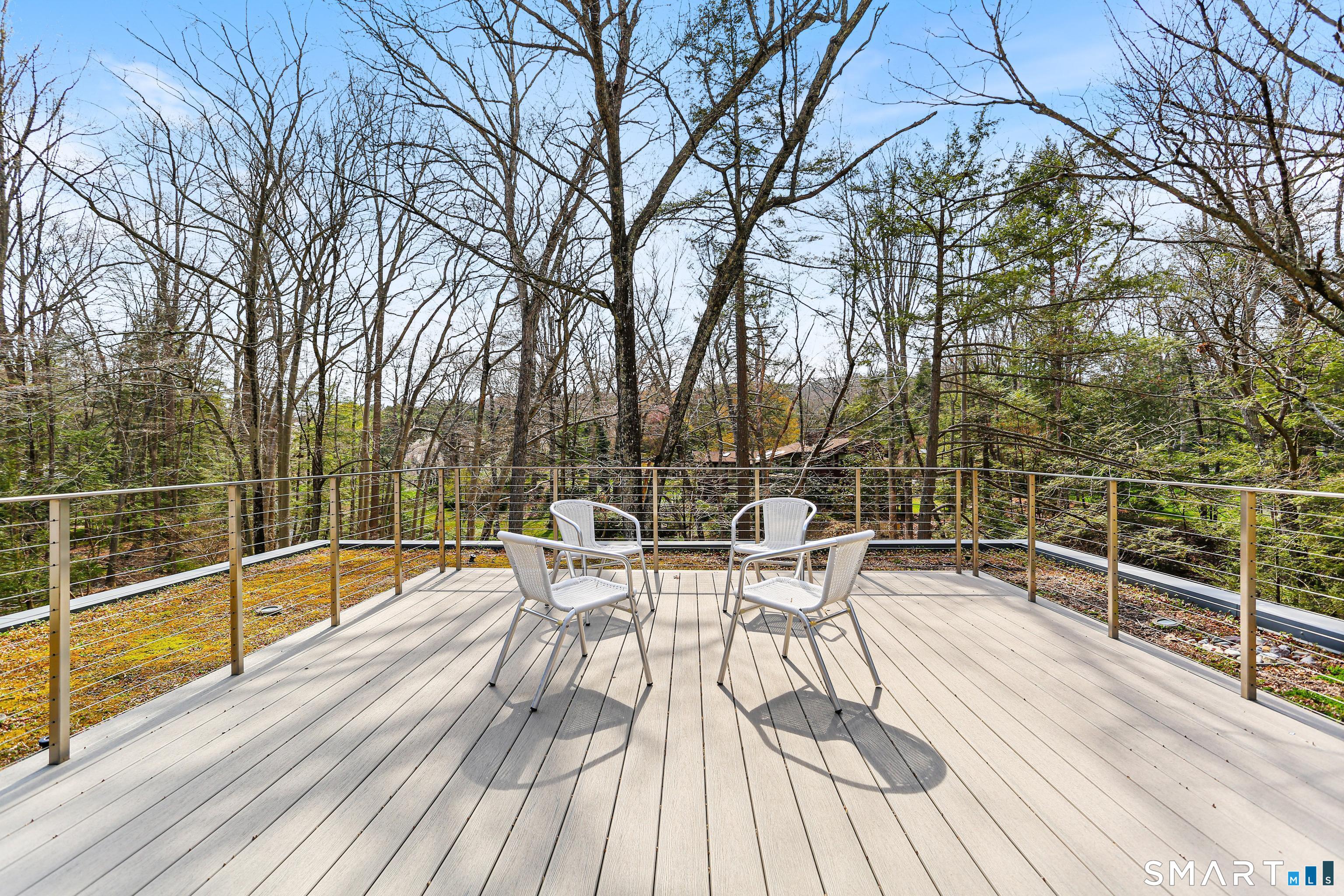 52 Valley Forge Road Weston, CT 06883 - Photo 27 of 38 a view of a roof deck with table and chairs wooden floor and fence