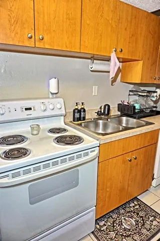 a kitchen with stainless steel appliances a stove a sink and a microwave