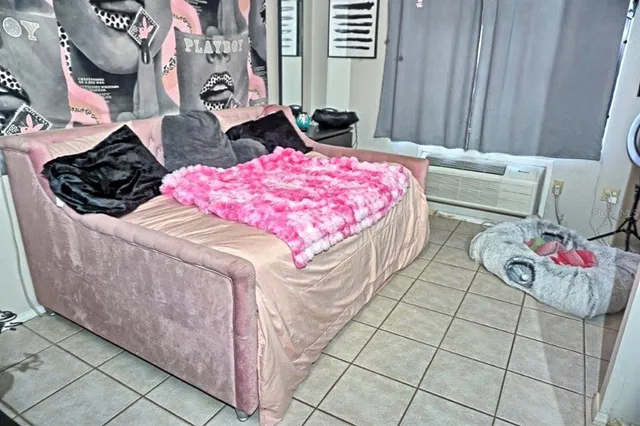 a bedroom with a bed and a closet with wooden floor