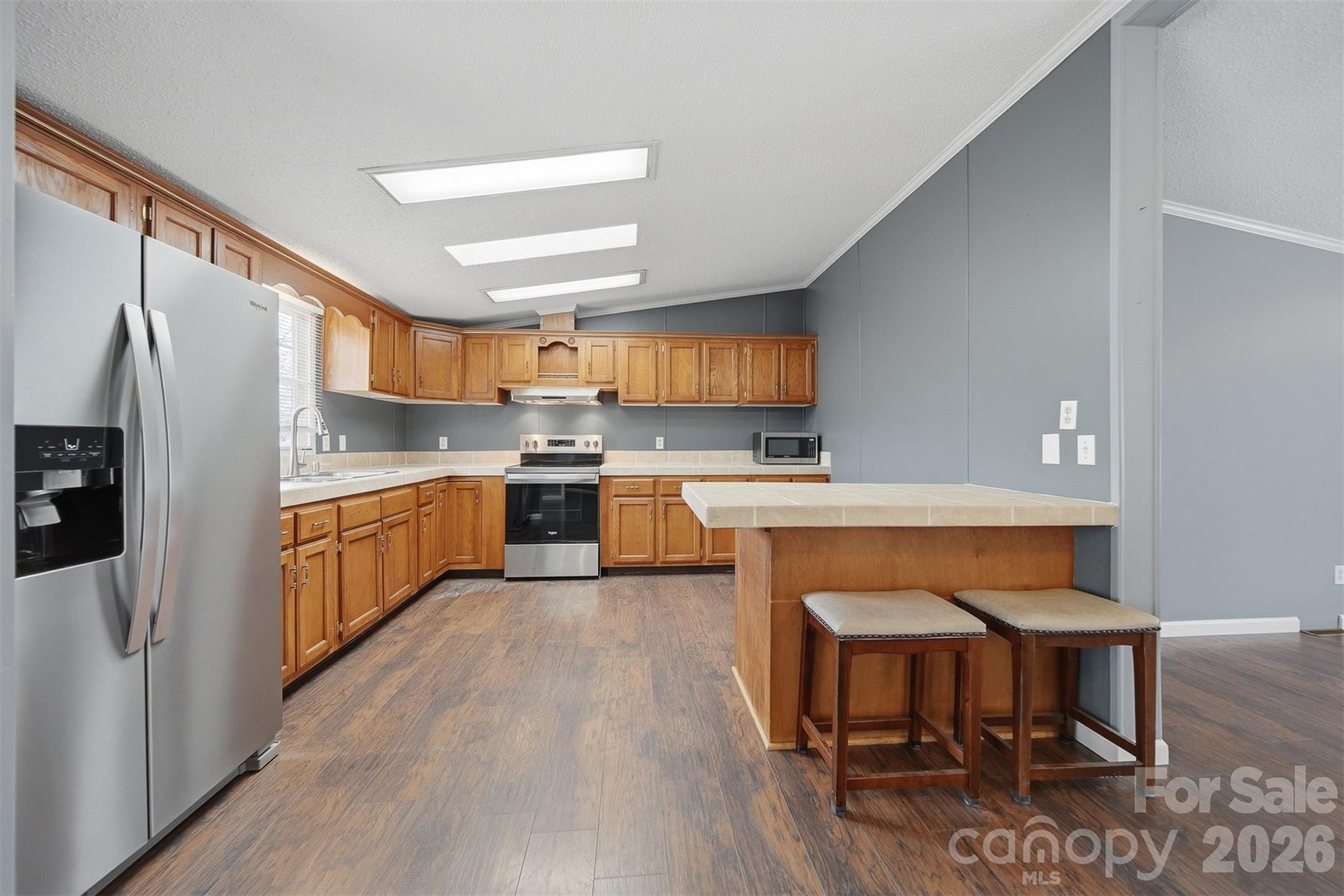 315 West McDowell Street Morganton, NC 28655 - Photo 12 of 48 a kitchen with stainless steel appliances a sink a stove a refrigerator cabinets and a dining table