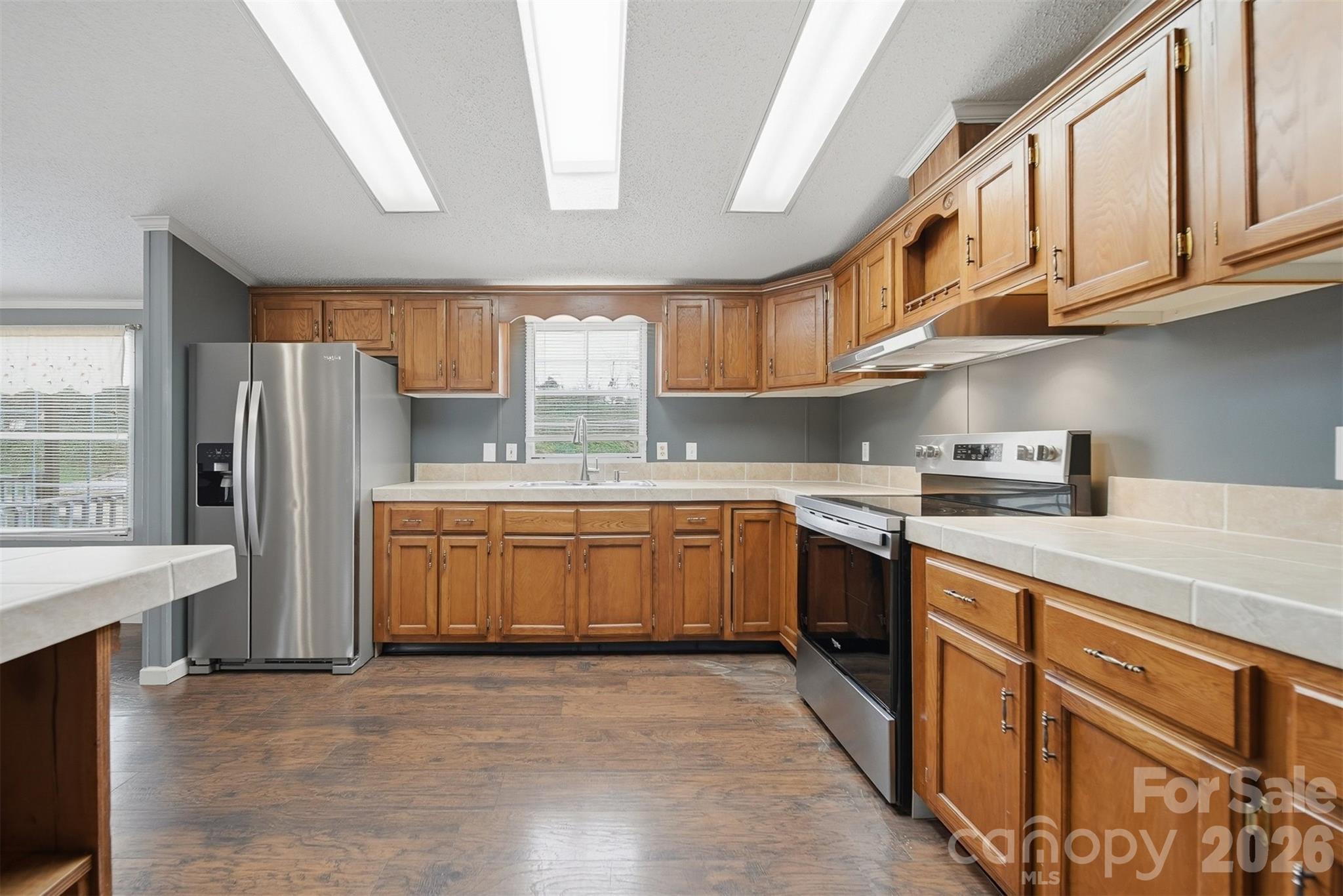 315 West McDowell Street Morganton, NC 28655 - Photo 15 of 48 a kitchen with stainless steel appliances granite countertop a refrigerator and a stove top oven