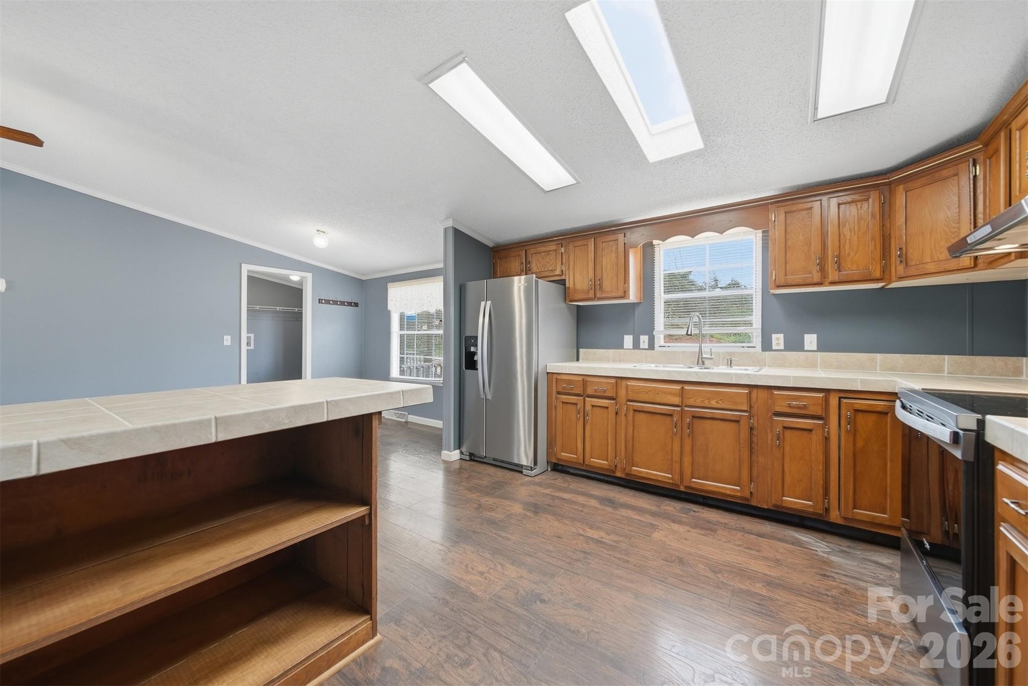 315 West McDowell Street Morganton, NC 28655 - Photo 16 of 48 a kitchen with stainless steel appliances kitchen island granite countertop a refrigerator and wooden cabinets