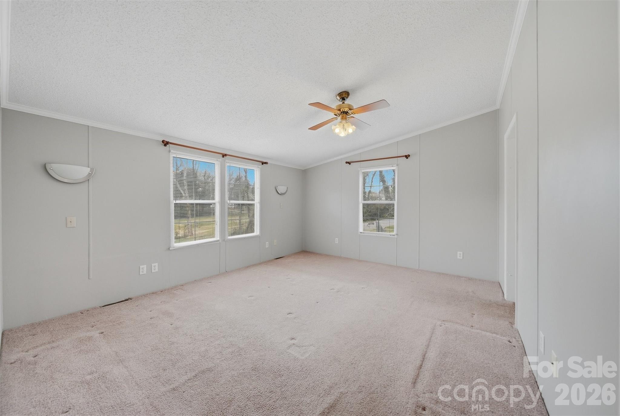 315 West McDowell Street Morganton, NC 28655 - Photo 19 of 48 an empty room with windows and chandelier fan