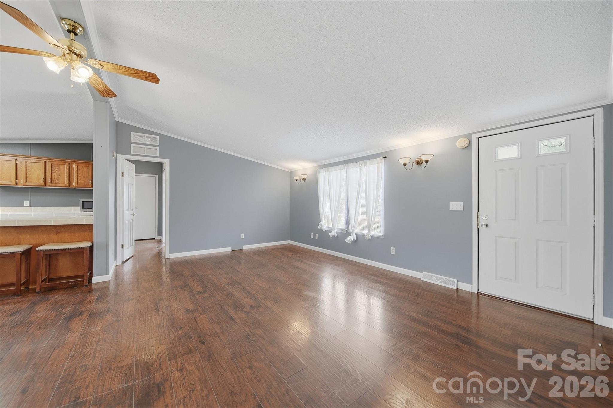 315 West McDowell Street Morganton, NC 28655 - Photo 3 of 48 a view of empty room with wooden floor and fan