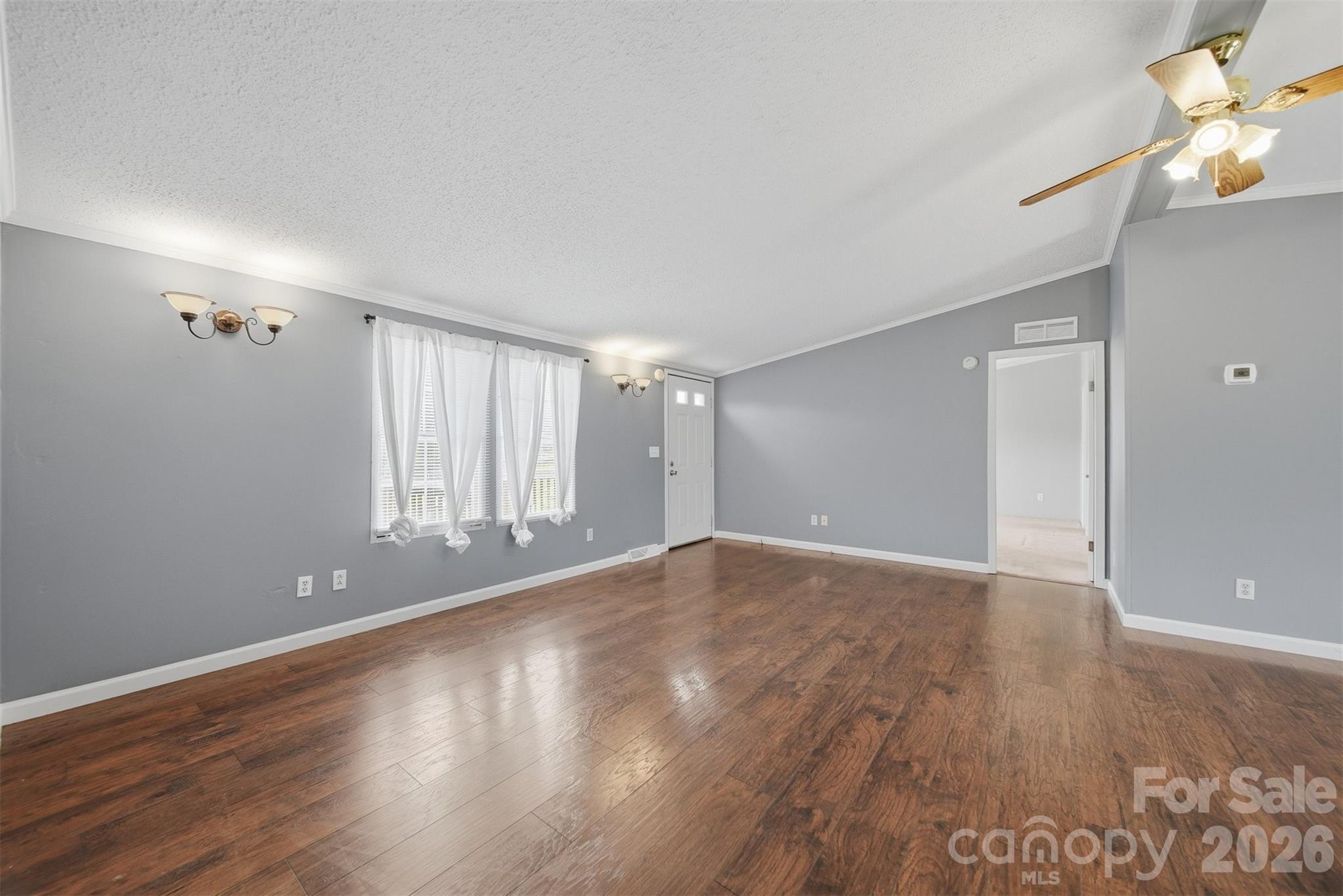315 West McDowell Street Morganton, NC 28655 - Photo 5 of 48 a view of an empty room with wooden floor and a window